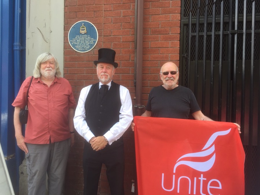 Unite members John Mooney and Anthony Shaw with historian Simon Entwistle at the plaque on Darwen Street111-31314